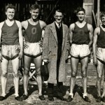 Black and white photo of the 1934 University of Oregon mile relay team flanking University President C. V. Boyer, after winning the Northwest Conference championship at Hayward Field. From left to right: Sherwood Burr, Bill Bowerman, Boyer, George Scharpf, and Howard Patterson. 